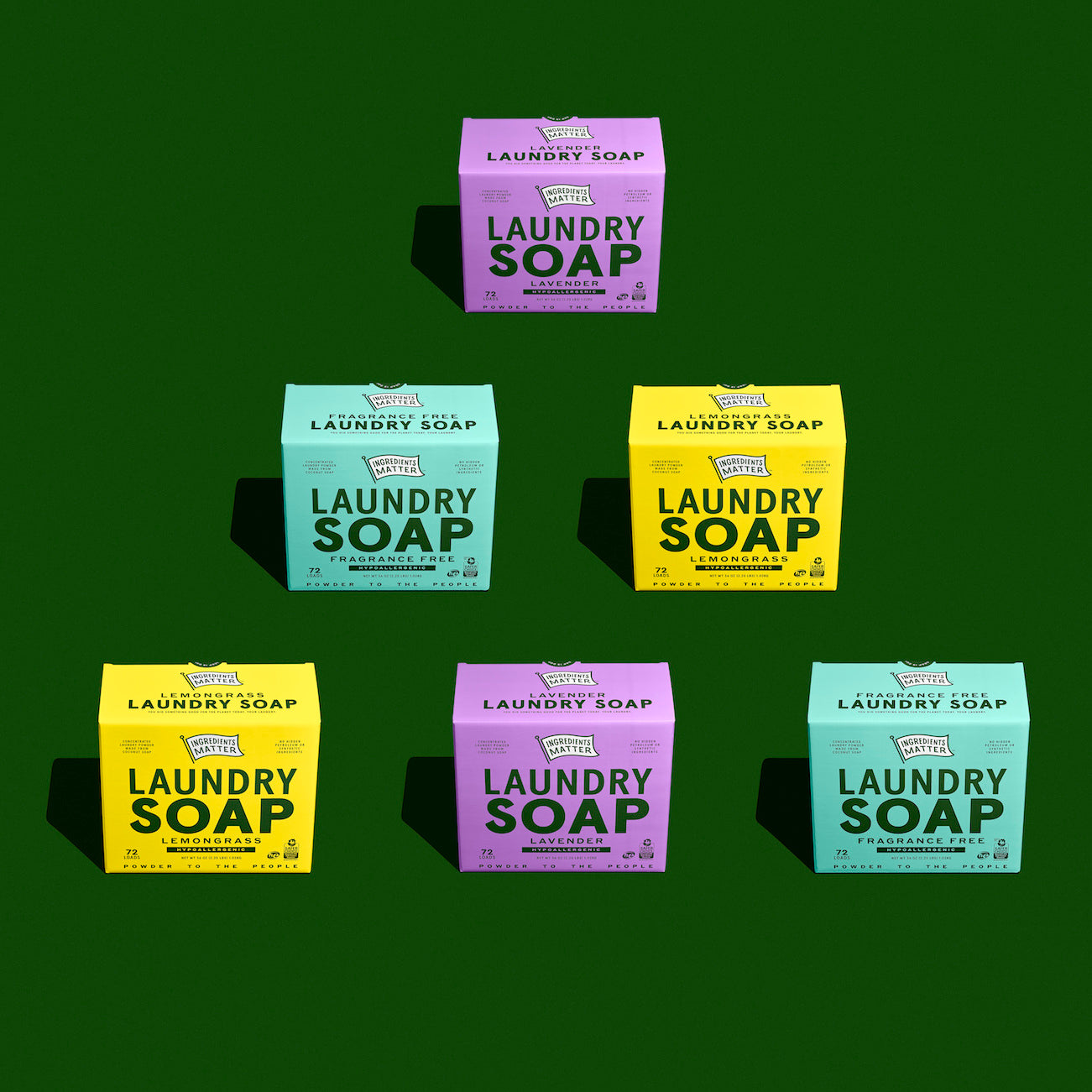 person washing hands in kitchen sink with foamy lather on hands, in the background foaming hand wash bottle and produce on counter